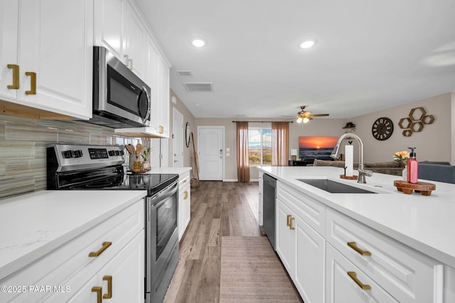 20217 E Yucca Dr, Mayer, AZ 86333 - kitchen featuring appliances with stainless steel finishes, a sink, open floor plan, backsplash, and recessed lighting