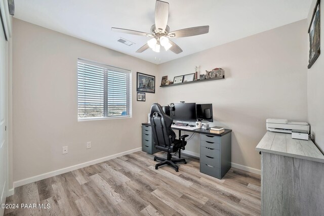 home office featuring light hardwood / wood-style floors and ceiling fan