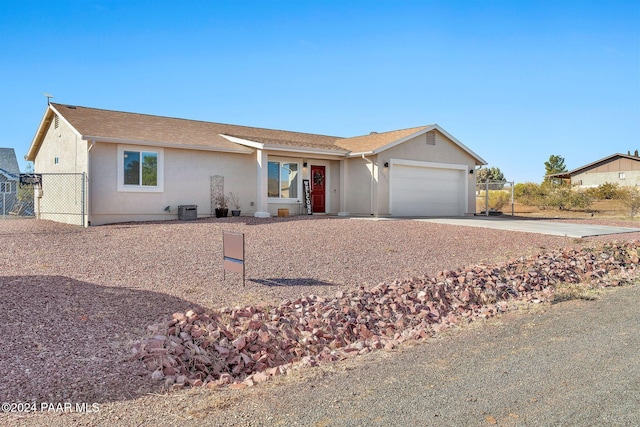 single story home with a garage and central air condition unit