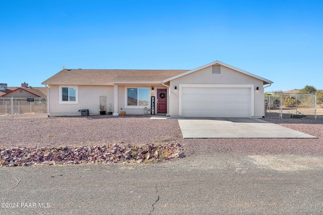 single story home featuring a garage and central air condition unit