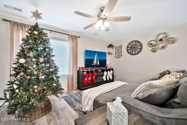 bedroom with ceiling fan and light hardwood / wood-style floors