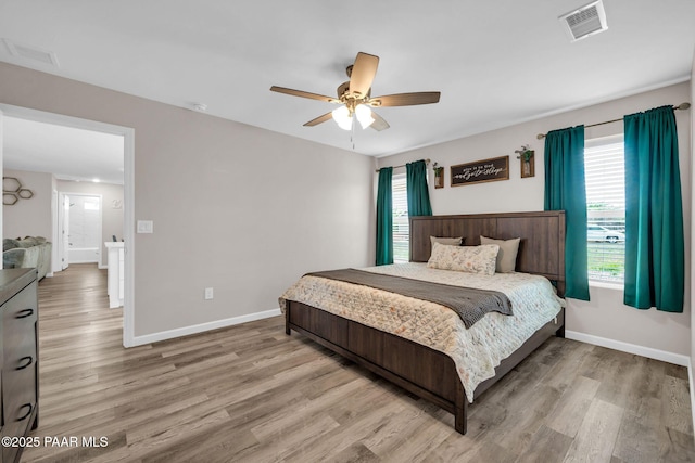 20217 E Yucca Dr, Mayer, AZ 86333 - bedroom with wood finished floors, multiple windows, and baseboards