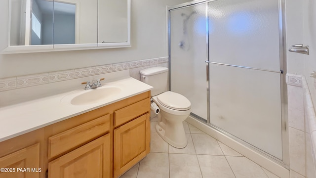 941 Custer Ln, Prescott, AZ 86305 - full bathroom with vanity, a stall shower, tile patterned floors, toilet, and tile walls
