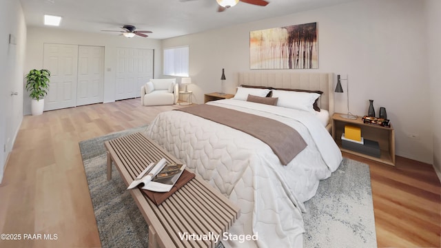 941 Custer Ln, Prescott, AZ 86305 - bedroom featuring wood finished floors, two closets, a ceiling fan, and baseboards