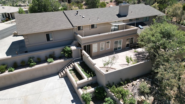 941 Custer Ln, Prescott, AZ 86305 - rear view of house featuring a balcony, stucco siding, a chimney, and a patio