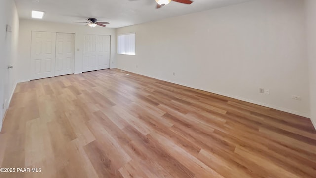 941 Custer Ln, Prescott, AZ 86305 - unfurnished bedroom with multiple closets, light wood-type flooring, baseboards, and a ceiling fan