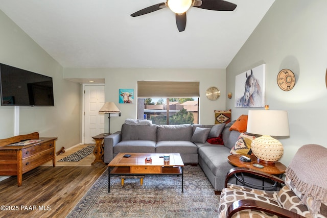 living area featuring ceiling fan, baseboards, vaulted ceiling, and wood finished floors