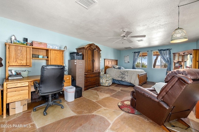 3900 W Runway Rd, Paulden, AZ 86334 - bedroom featuring an office area, a textured ceiling, ceiling fan, and light stone finish floors