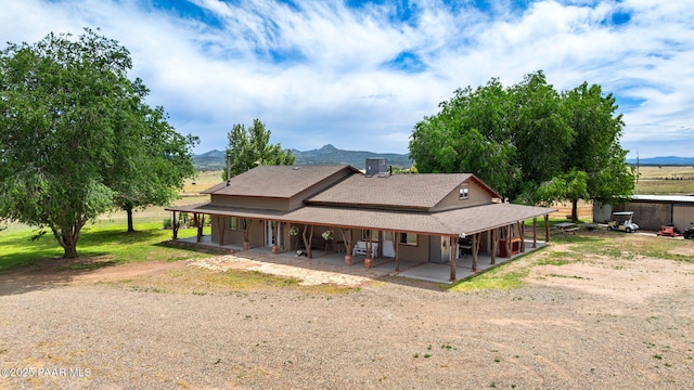 3900 W Runway Rd, Paulden, AZ 86334 - rear view of property with a porch, a mountain view, and a shingled roof