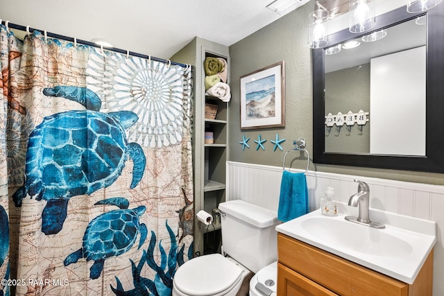3900 W Runway Rd, Paulden, AZ 86334 - full bath featuring a wainscoted wall, vanity, and a shower with shower curtain