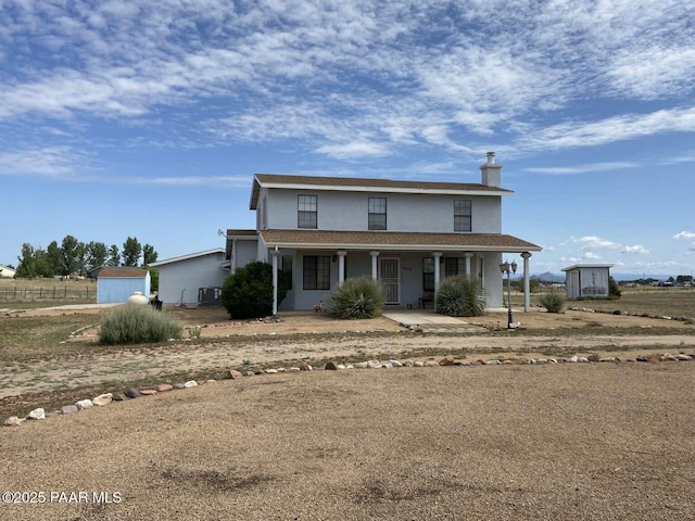 1350 W Justray Ranch Rd, Chino Valley, AZ 86323 - view of front of home featuring a porch, a storage unit, and stucco siding