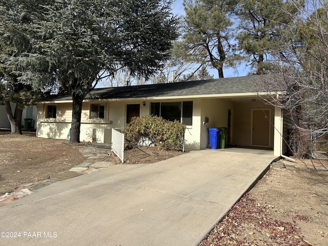 view of front of property featuring a carport