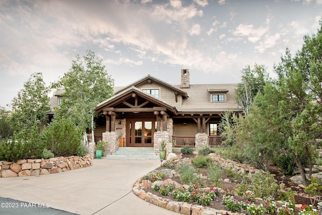 craftsman inspired home with french doors and covered porch