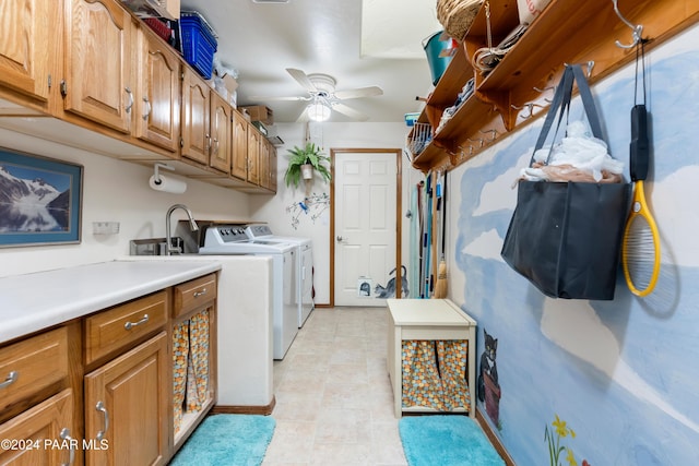 laundry area featuring cabinets, washer and clothes dryer, and ceiling fan