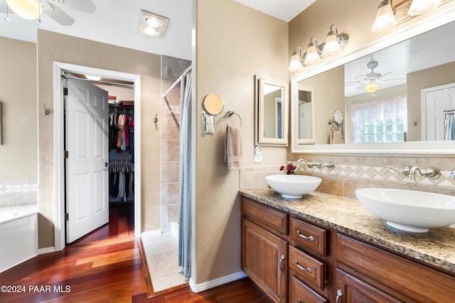 bathroom with wood-type flooring, vanity, ceiling fan, and backsplash