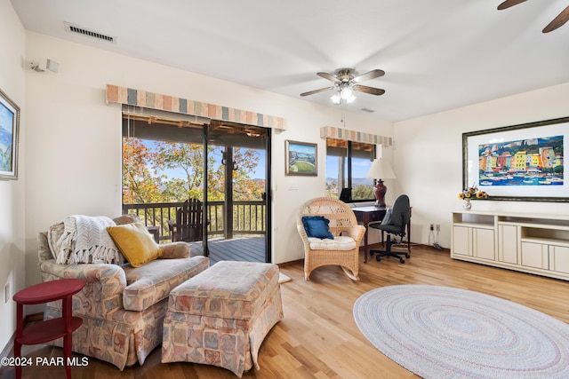 sitting room with light wood-type flooring and ceiling fan