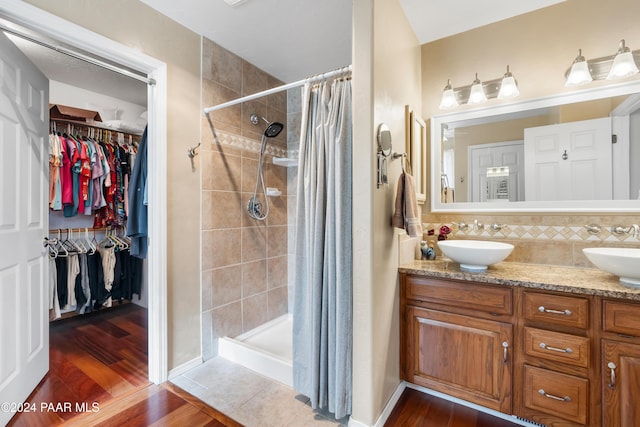 bathroom featuring a shower with shower curtain, hardwood / wood-style floors, and vanity