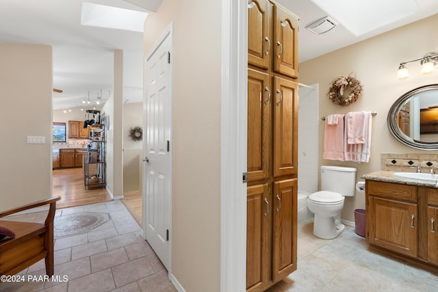 bathroom with tasteful backsplash, tile patterned flooring, vanity, and toilet