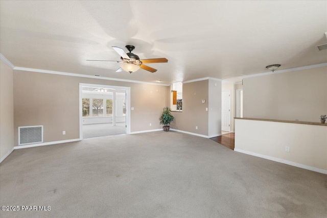unfurnished living room with crown molding, carpet, visible vents, and a ceiling fan