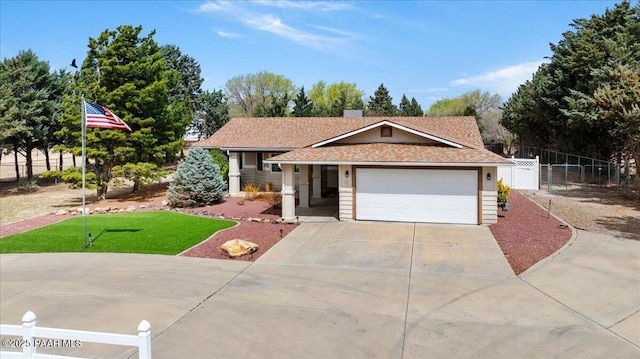 ranch-style home with a garage, fence, concrete driveway, and a gate