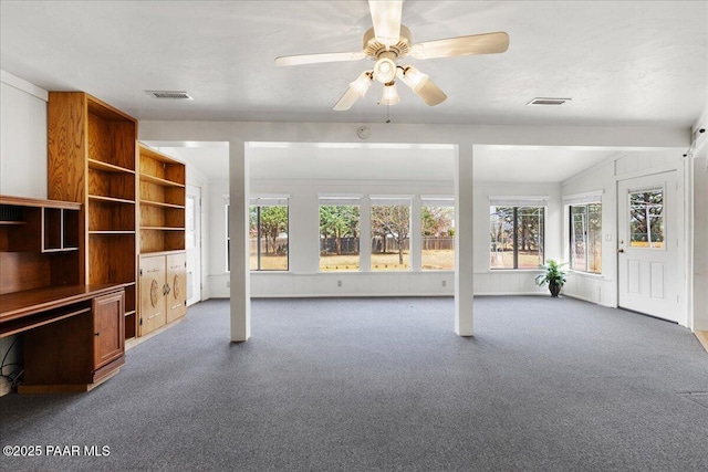 unfurnished living room with carpet floors, lofted ceiling, ceiling fan, and visible vents