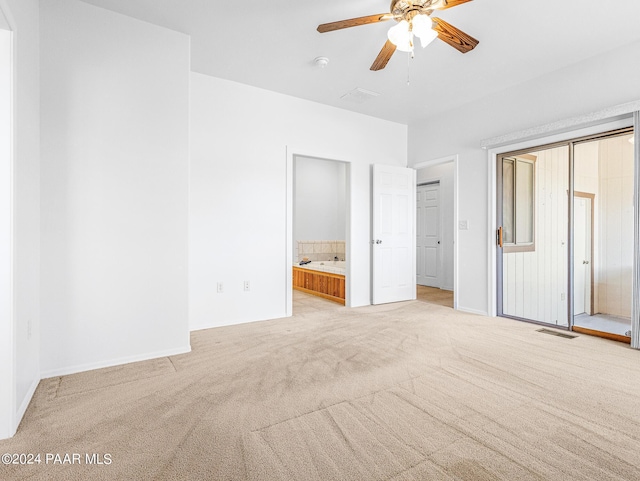 18301 S Peeples Valley Rd, Peeples Valley, AZ 86332 - unfurnished bedroom featuring ensuite bath, ceiling fan, and light colored carpet
