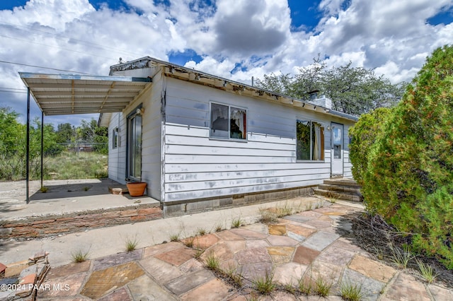 view of side of home with a patio area