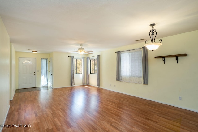 439 Foxfire Ln, Prescott, AZ 86301 - unfurnished living room with wood finished floors, ceiling fan, and baseboards