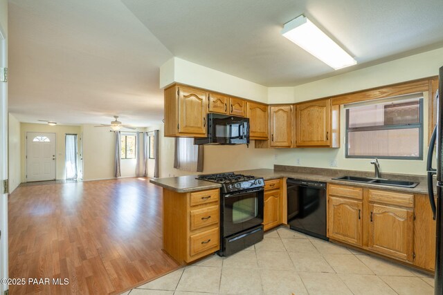 439 Foxfire Ln, Prescott, AZ 86301 - kitchen with black appliances, a sink, brown cabinets, open floor plan, and a peninsula