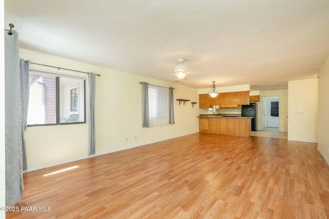 439 Foxfire Ln, Prescott, AZ 86301 - unfurnished living room featuring light wood-style flooring, a ceiling fan, and baseboards