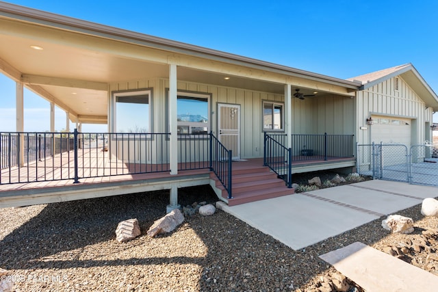 doorway to property with a garage and covered porch