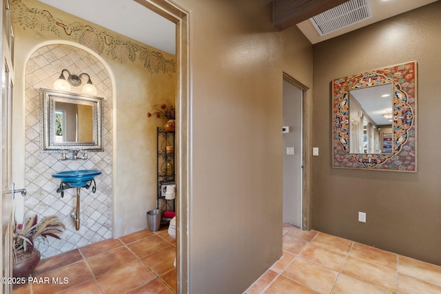 hallway featuring tile patterned flooring