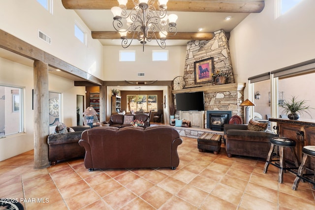 living room featuring plenty of natural light, beamed ceiling, a high ceiling, and an inviting chandelier