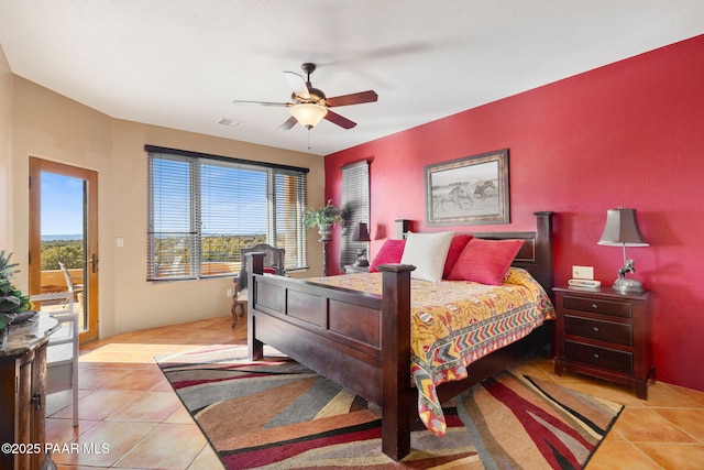 bedroom with ceiling fan, light tile patterned flooring, and access to outside