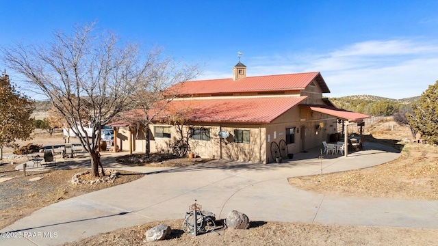 view of front facade with a mountain view and a patio