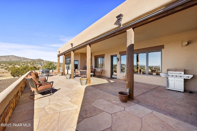 view of patio / terrace with a mountain view and area for grilling