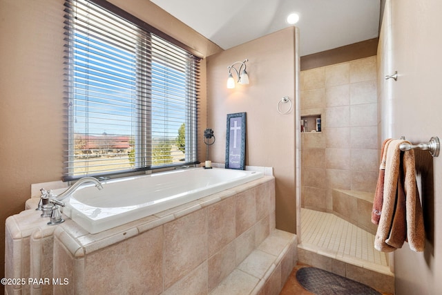 bathroom with a healthy amount of sunlight and shower with separate bathtub