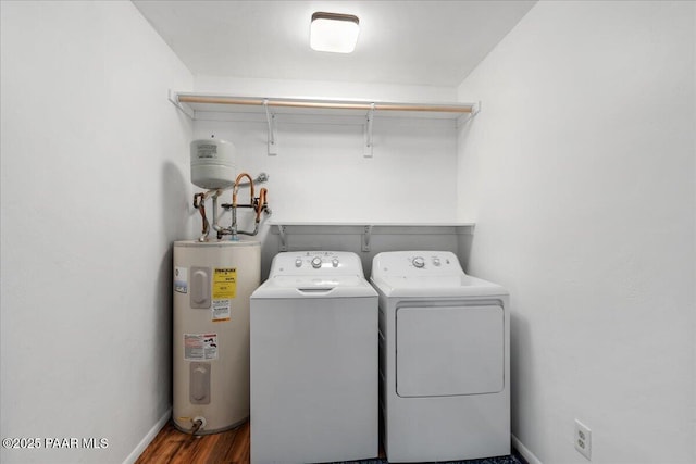 washroom featuring washer and dryer, dark hardwood / wood-style floors, and water heater