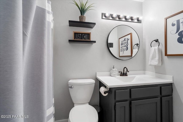 bathroom featuring toilet and vanity