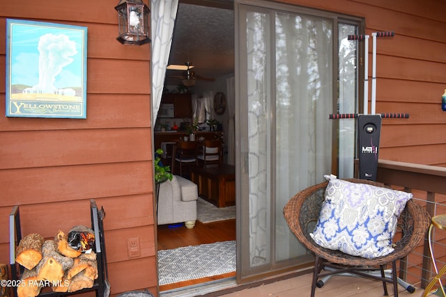 exterior space with wood finished floors and a ceiling fan