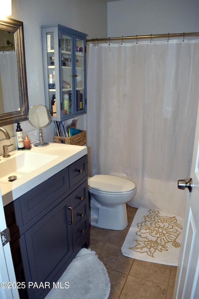 bathroom featuring tile patterned floors, toilet, and vanity