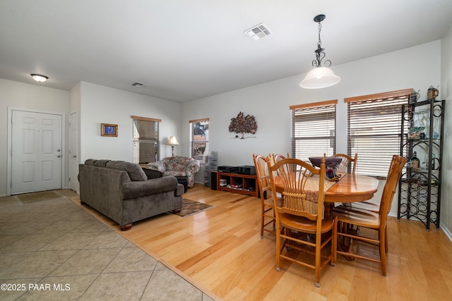 dining area featuring visible vents, a healthy amount of sunlight, and light wood-style flooring