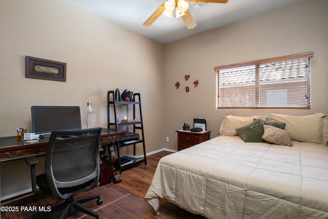 bedroom featuring ceiling fan, baseboards, and wood finished floors