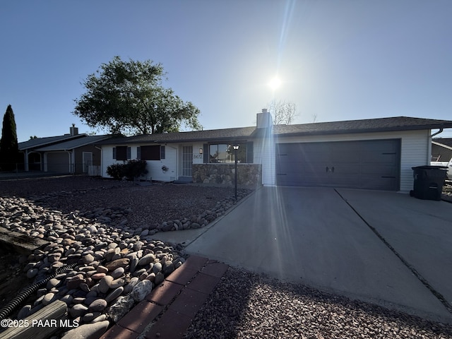 8470 E Sommer Dr, Prescott Valley, AZ 86314 - ranch-style house with concrete driveway, a garage, and a chimney