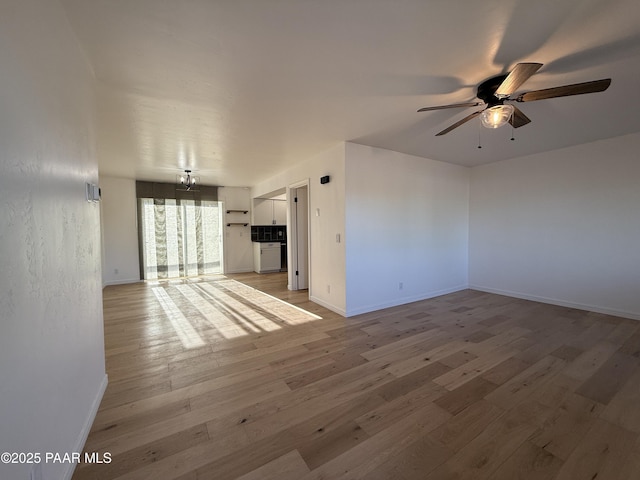 8470 E Sommer Dr, Prescott Valley, AZ 86314 - unfurnished living room with ceiling fan, light wood finished floors, and baseboards