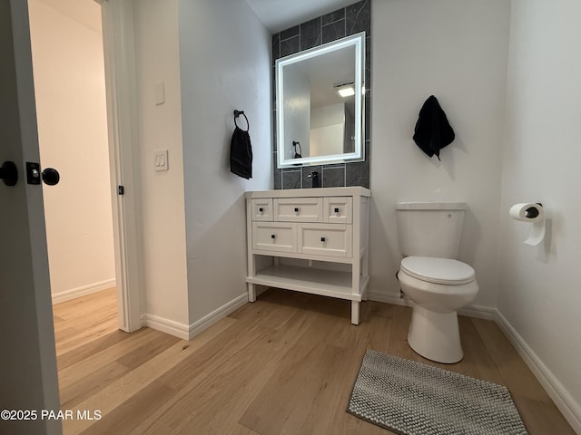 8470 E Sommer Dr, Prescott Valley, AZ 86314 - bathroom with toilet, wood finished floors, vanity, and baseboards