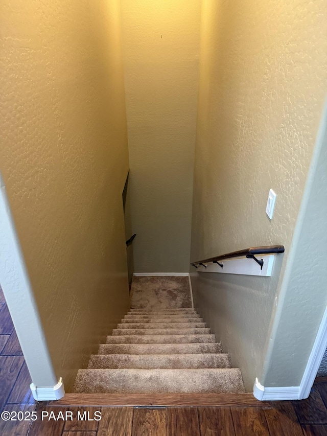 stairs featuring wood-type flooring