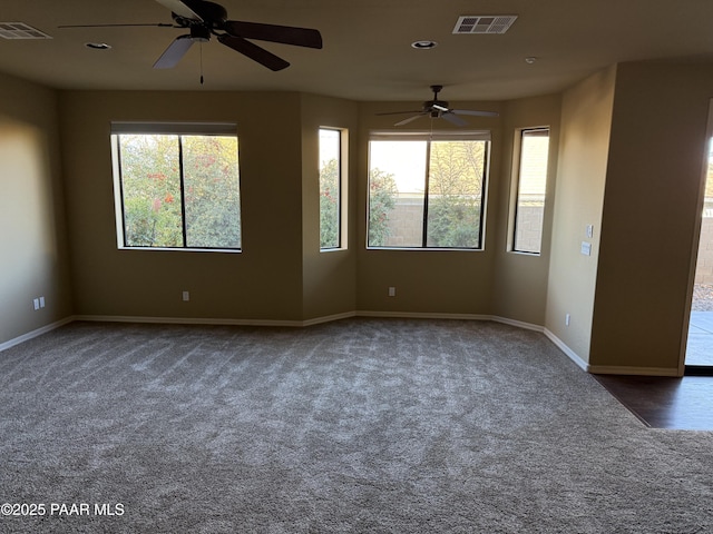 carpeted empty room featuring ceiling fan