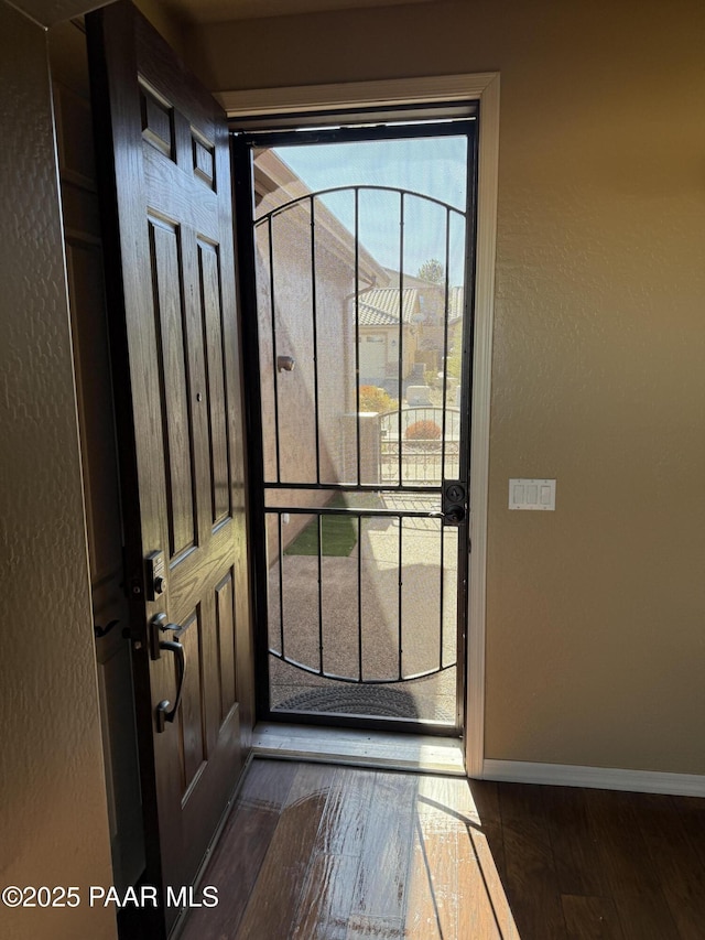 doorway with dark wood-type flooring