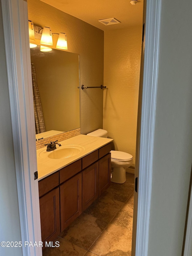 bathroom with toilet and vanity